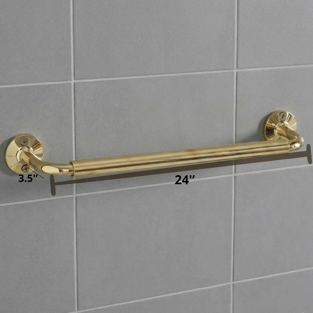 Detailed view of a luxury brass bathroom rail with a white towel, highlighting the sturdy wall-mount flanges and polished gold finish against a grey tiled backdrop.