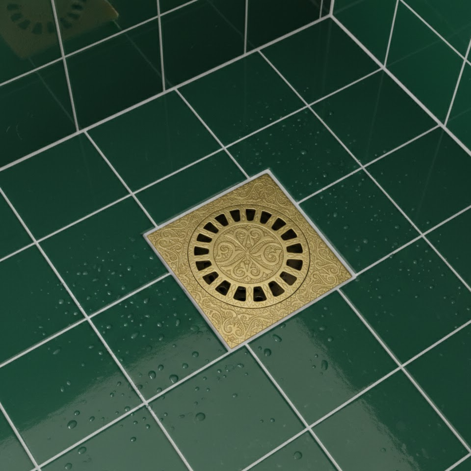 Solid brass square shower floor drain installed in green tiled bathroom floor.