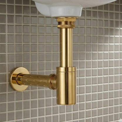 Close-up of 1-1/4 inch unlacquered brass bottle P-trap with round box flange and wall drain outlet installed under a white bathroom sink
