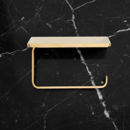 Side angle view of an antique-style unlacquered brass toilet paper holder with top shelf for bathroom essentials