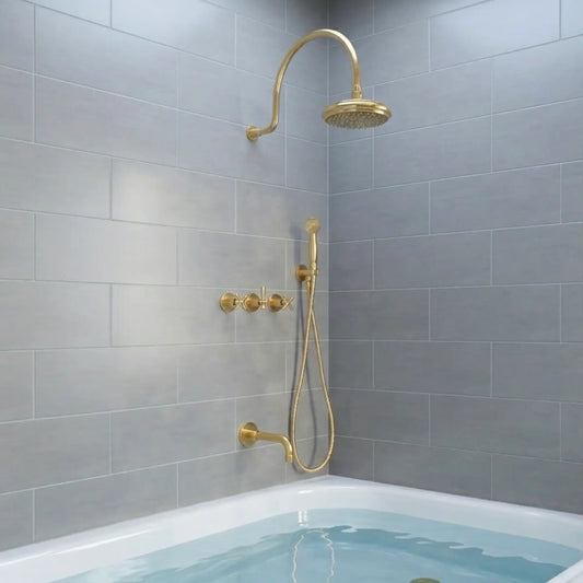 BrassOna® Aurelia unlacquered brass rainfall shower system with handheld sprayer, tub spout and cross handles — full set installed in modern gray tiled bathroom