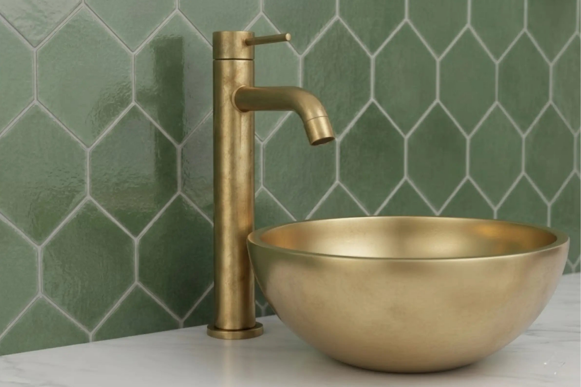 BrassOna unlacquered brass vessel sink and tall faucet against green hexagon tile wall