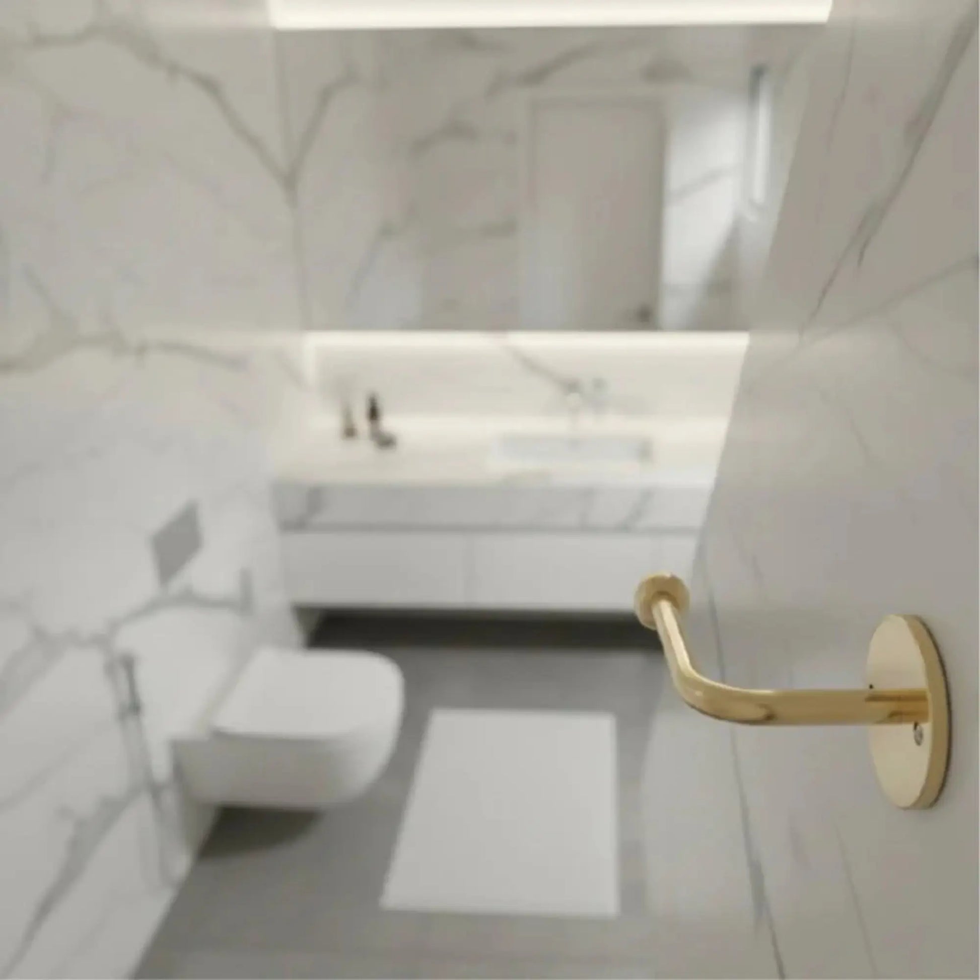 Top view of modern marble bathroom with wall-mounted unlacquered brass toilet paper holder, solid brass bathroom hardware with natural patina finish