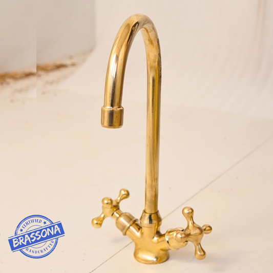 Solid unlacquered brass gooseneck basin faucet with vintage double cross handles, featuring a tall curved spout and living brass finish.