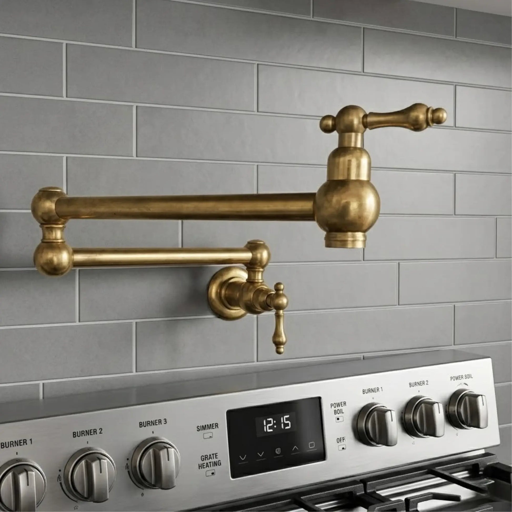 Wall-mounted unlacquered brass pot filler faucet with a double-jointed swing arm installed over a professional range with grey subway tile backsplash.