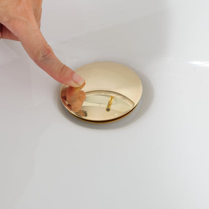 Hand pressing an unlacquered brass pop-up sink drain demonstrating one-touch push-button operation