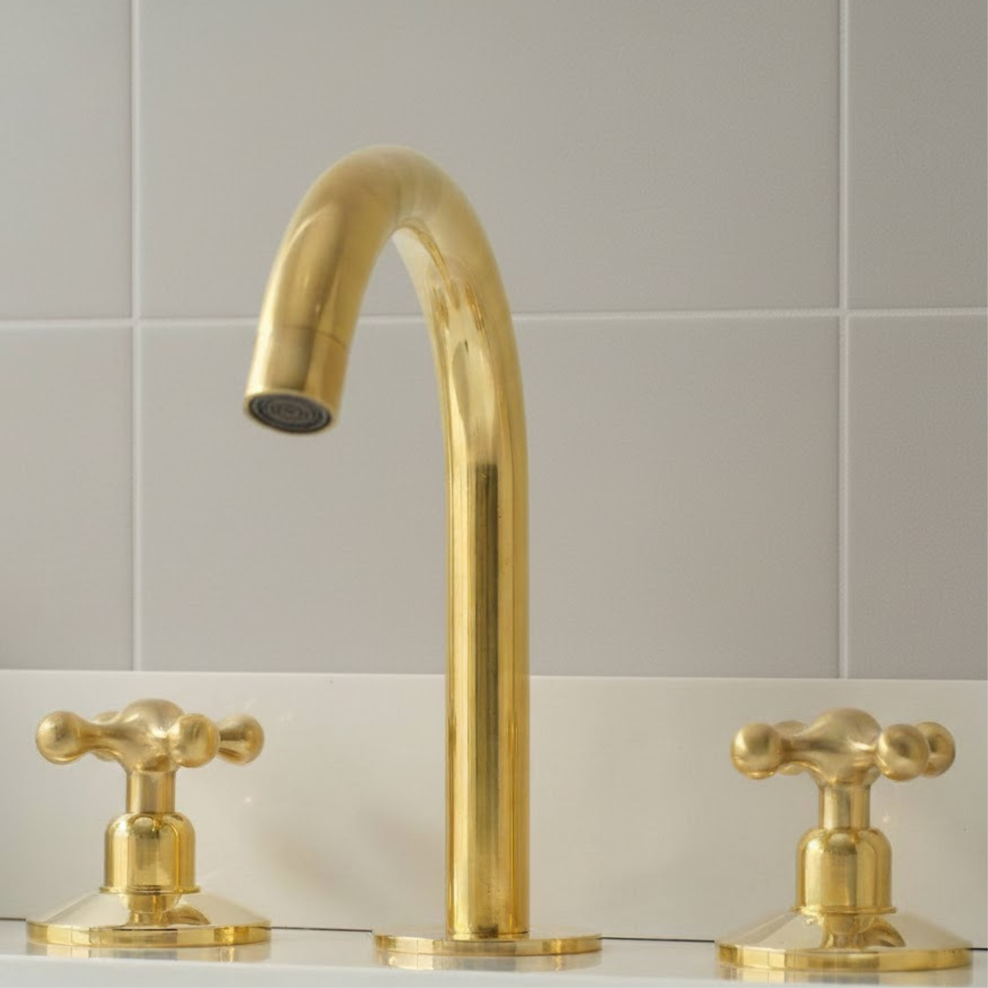 Solid unlacquered brass bathroom faucet spout with vintage cross handles and deck mount design