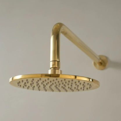 Gold shower head with arm on a plain background