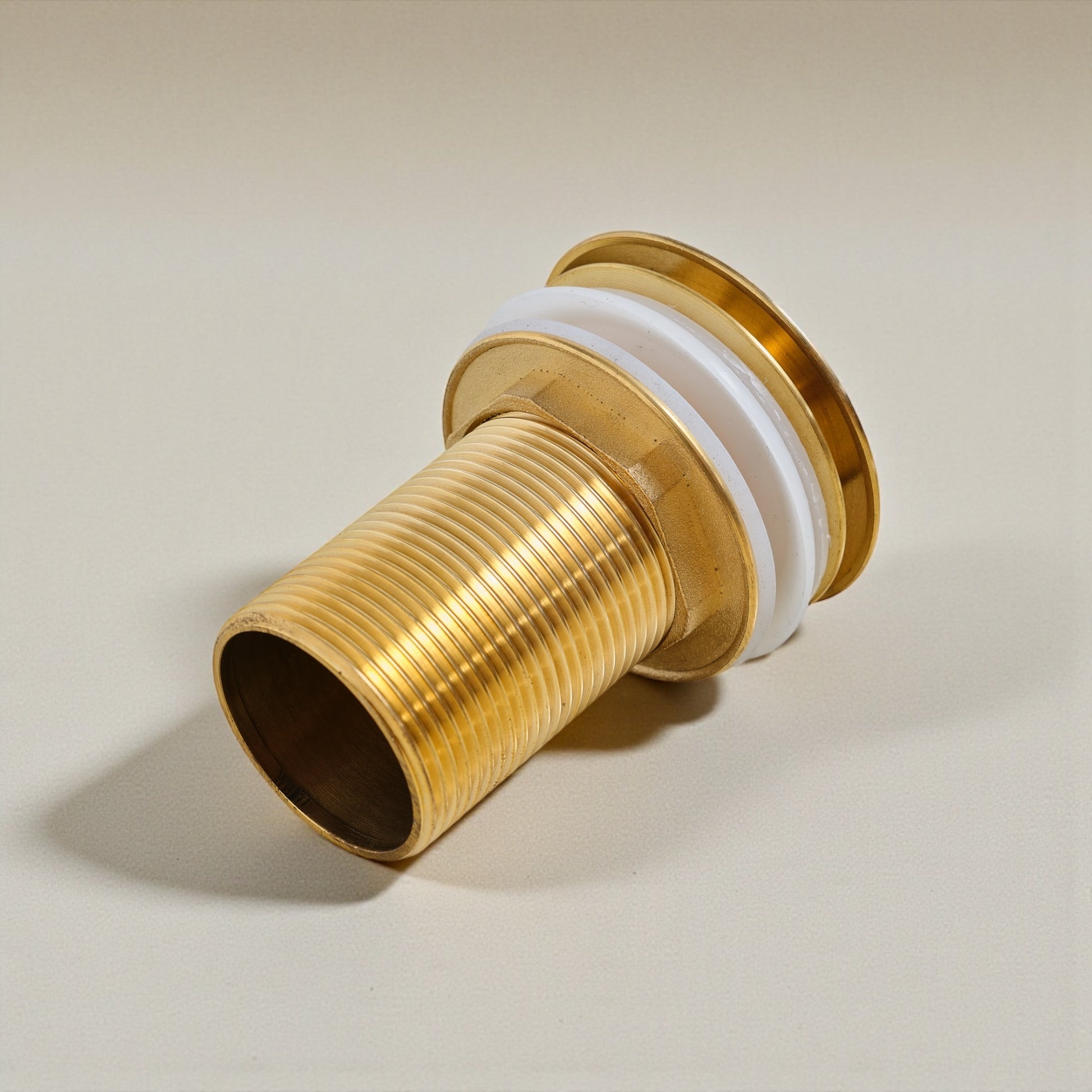Solid unlacquered brass pop-up sink drain with threaded body and push-button stopper for bathroom sinks