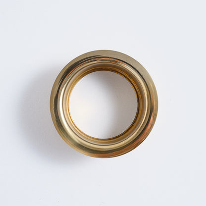 Overhead view showing the circular design and unlacquered finish of the brass flange.