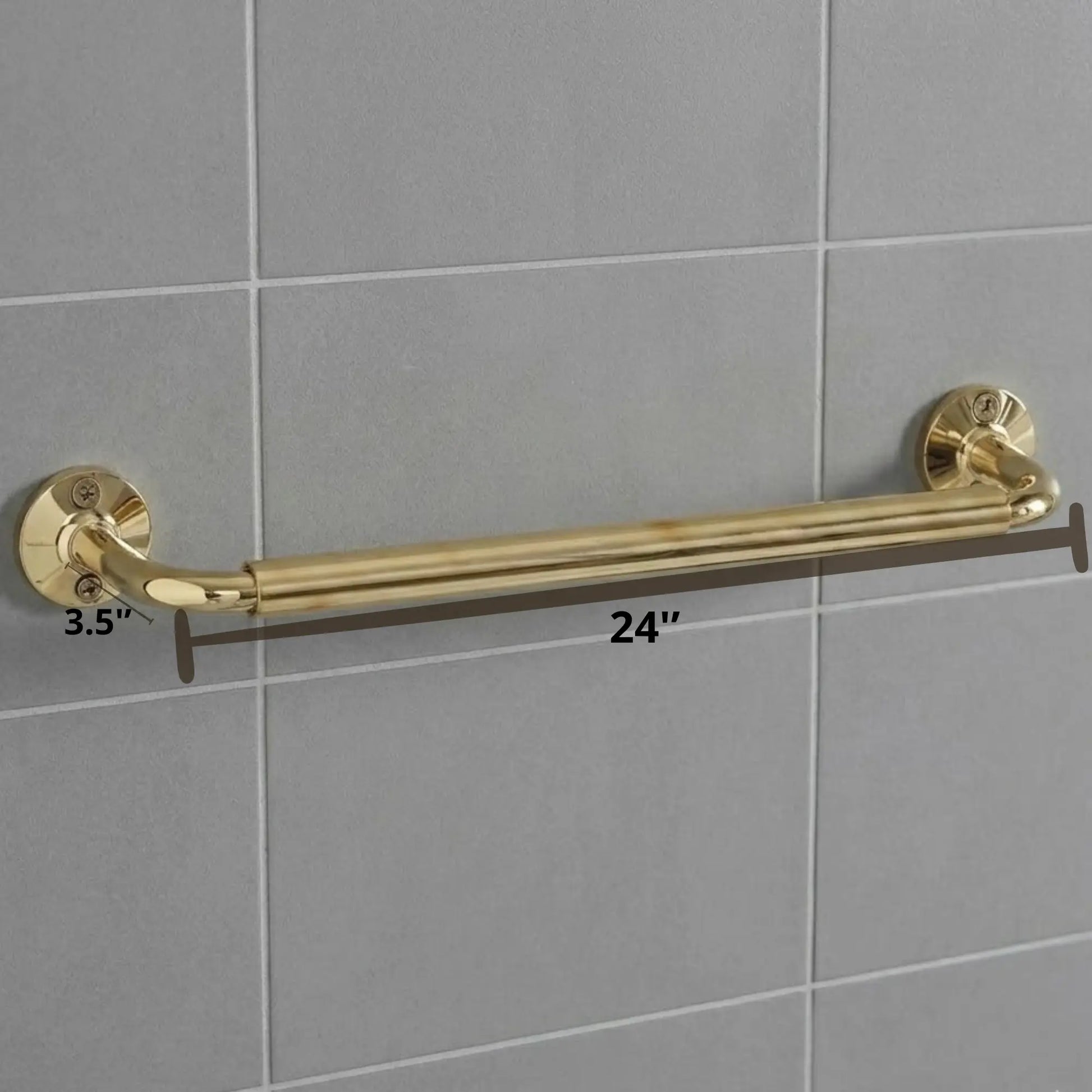 Detailed view of a luxury brass bathroom rail with a white towel, highlighting the sturdy wall-mount flanges and polished gold finish against a grey tiled backdrop.