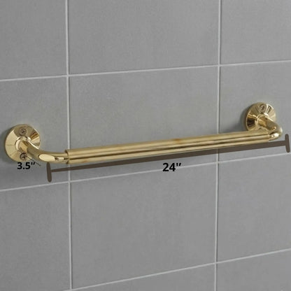 Detailed view of a luxury brass bathroom rail with a white towel, highlighting the sturdy wall-mount flanges and polished gold finish against a grey tiled backdrop.