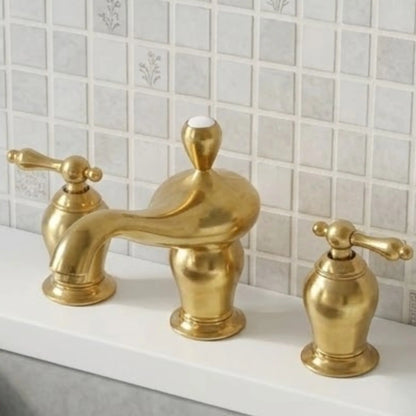 Aurelia unlacquered brass widespread bathroom faucet close-up showing gooseneck spout and lever handles