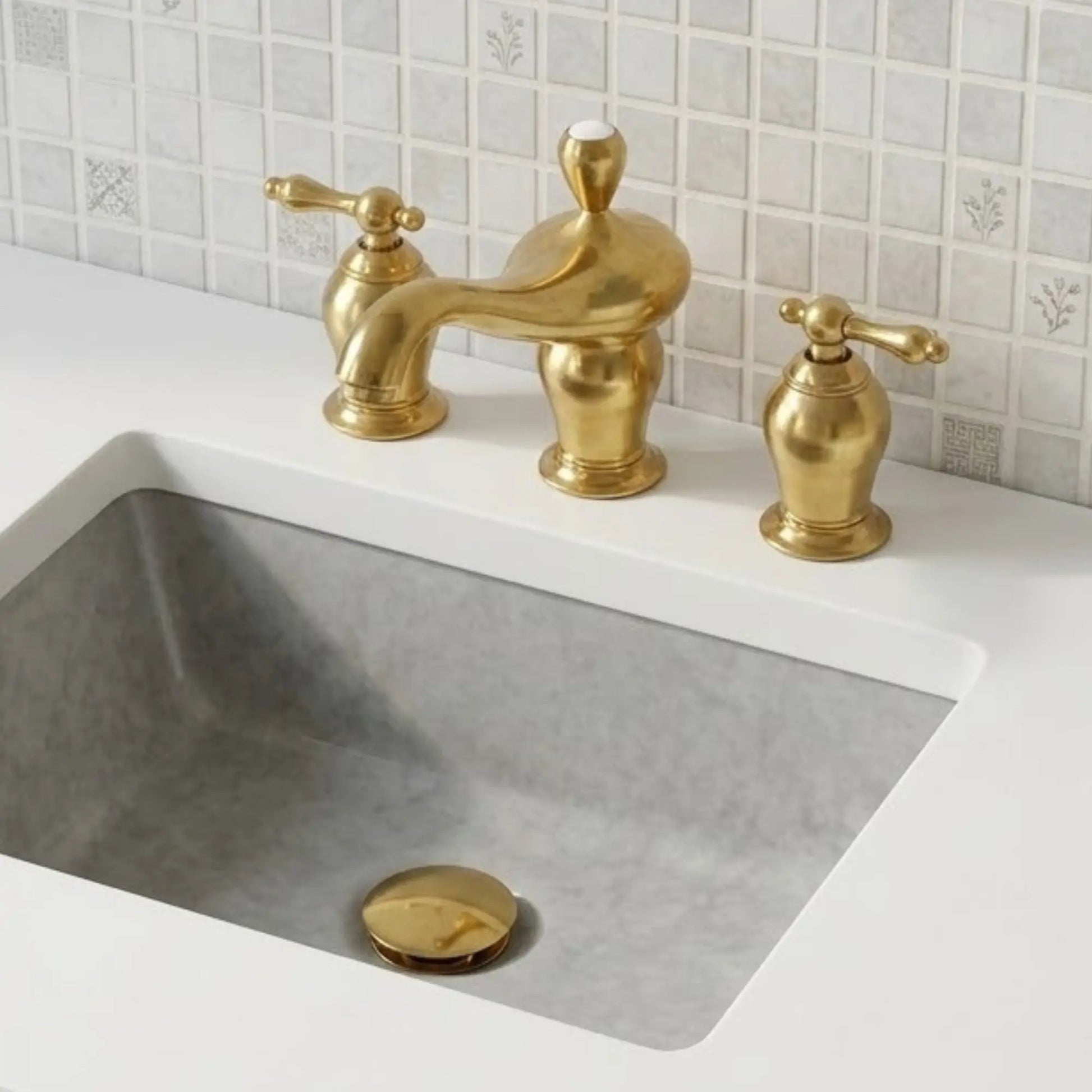 Aurelia unlacquered brass widespread bathroom faucet with lever handles installed on marble sink vanity
