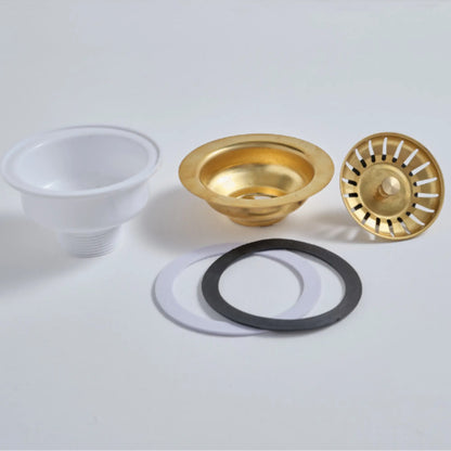 Exploded view of the brass sink drain showing the solid brass top, rubber gasket, and durable PVC base.