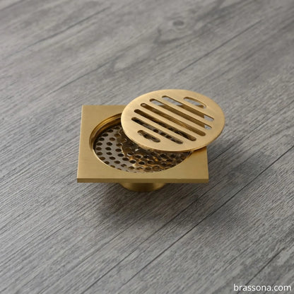 Solid brass floor drain with removable round strainer cover