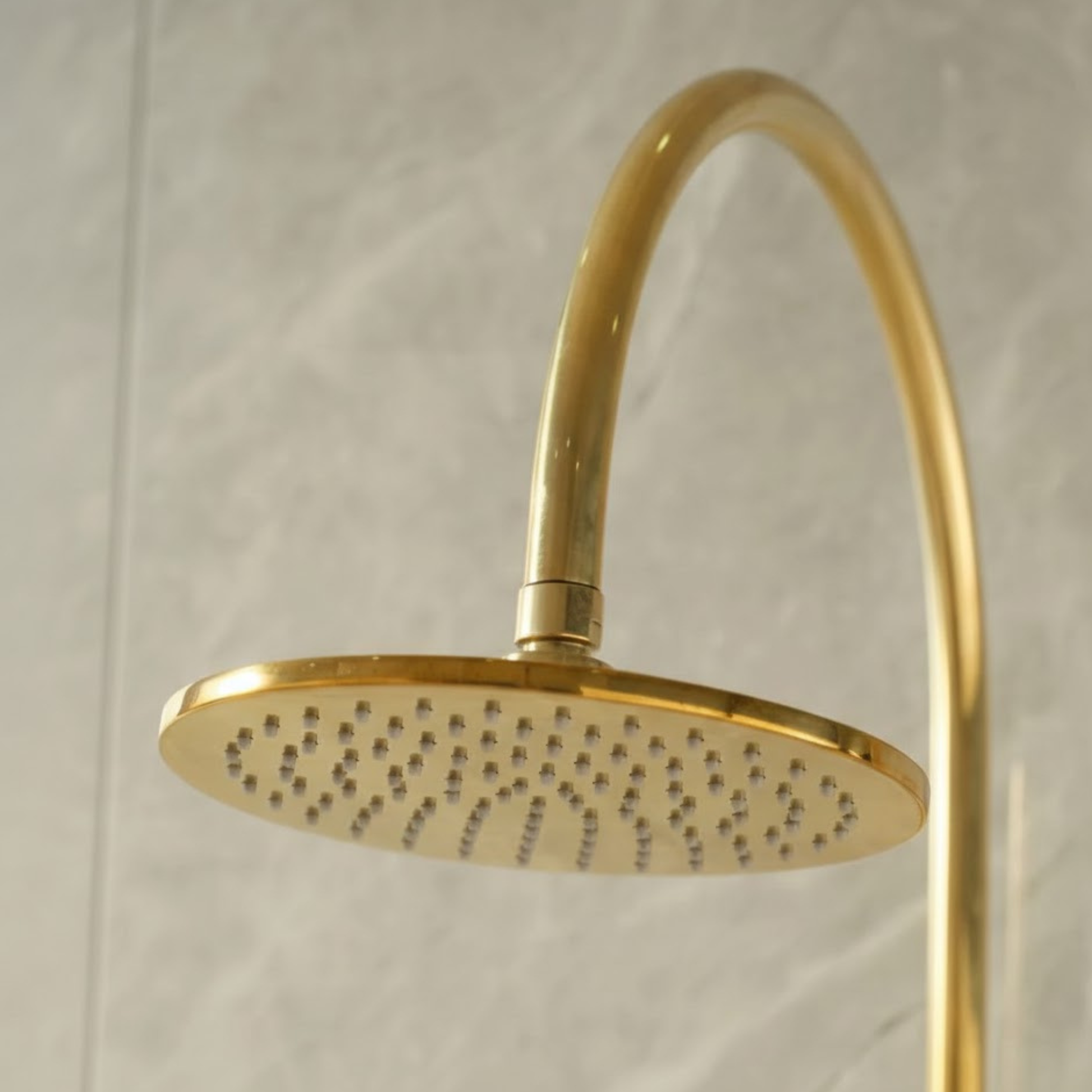Underside view of the circular brass rainfall shower head highlighting the precision-drilled easy-clean nozzles.