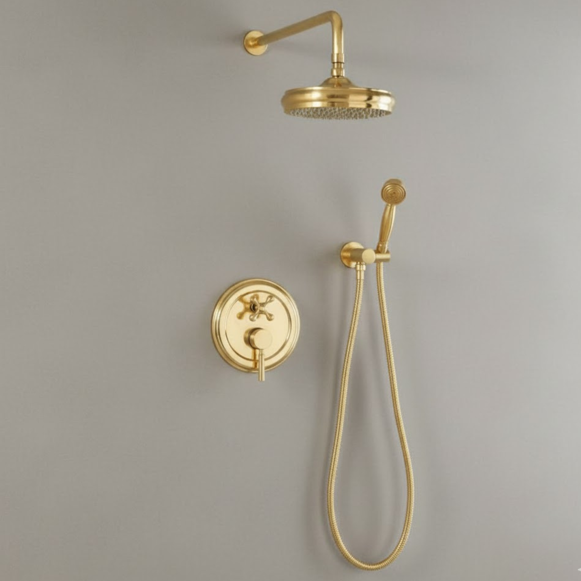 Side-by-side view of the unlacquered brass wall-mounted rainfall shower head and the matching handheld sprayer with hose.