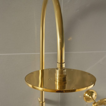 Close-up of the solid unlacquered brass vertical riser pipe and adjustable wall support bracket.