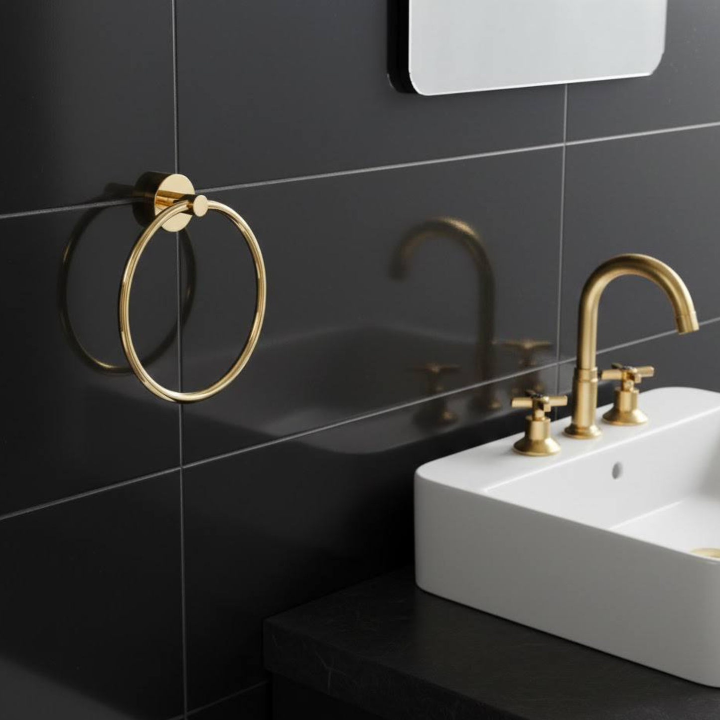 Solid unlacquered brass towel ring installed near bathroom sink with matching brass fixtures