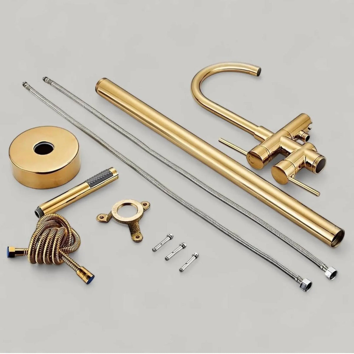 unlacquered brass freestanding faucet set with various components on a gray background