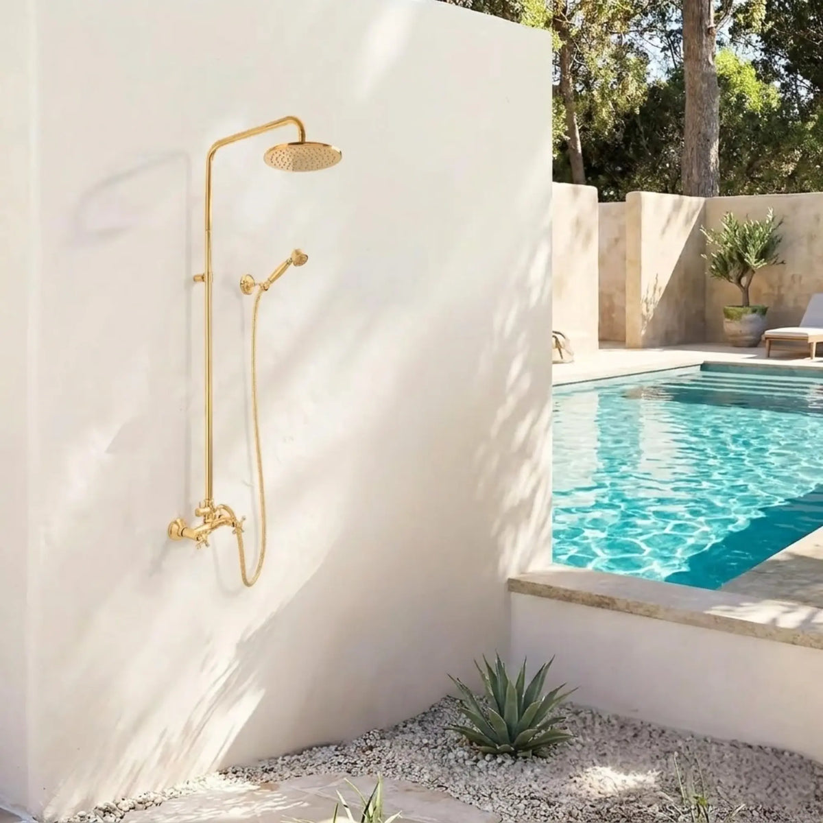 BrassOna® unlacquered brass outdoor rainfall shower system with handheld sprayer mounted on white wall next to swimming pool