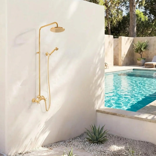 BrassOna® unlacquered brass outdoor rainfall shower system with handheld sprayer mounted on white wall next to swimming pool