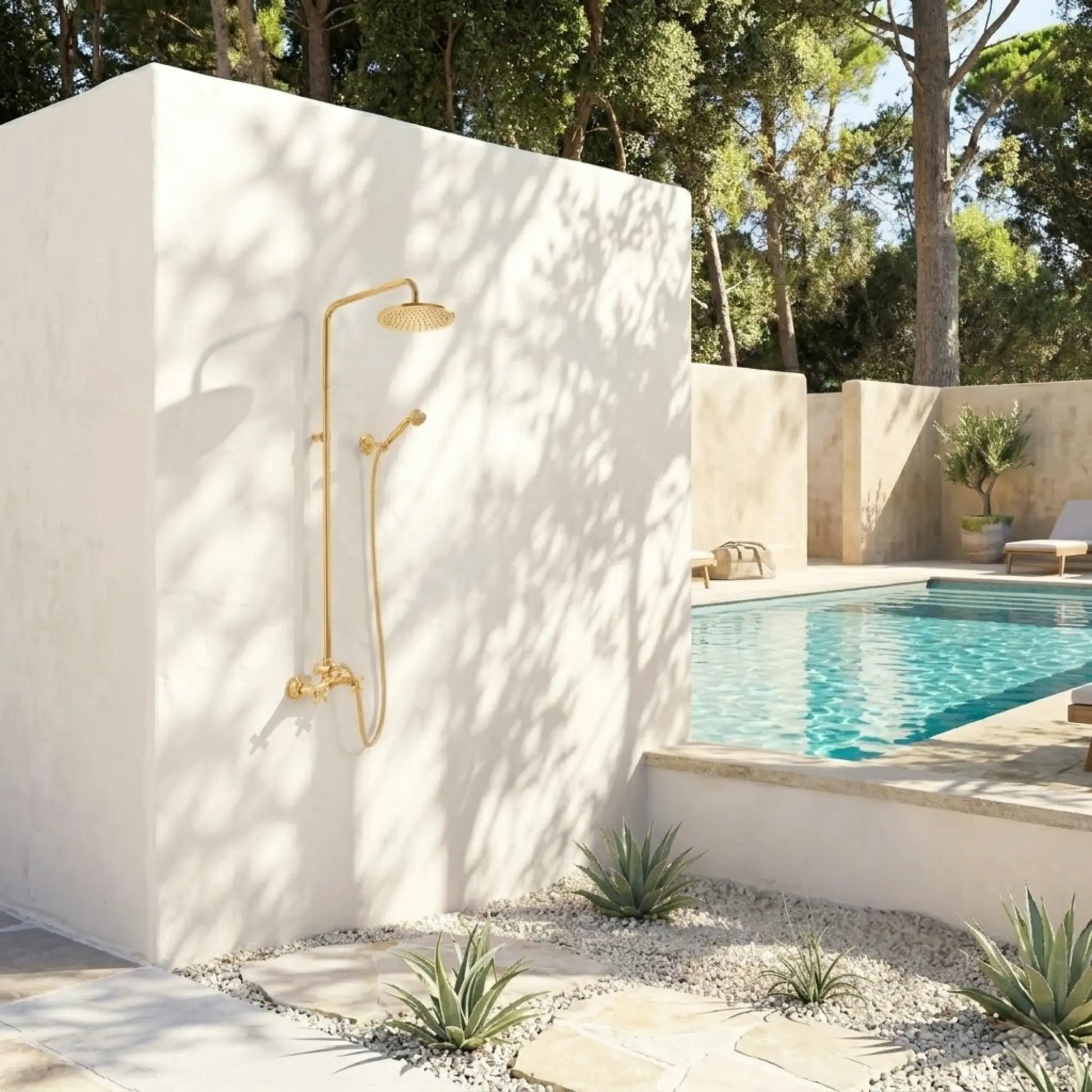 BrassOna® unlacquered brass outdoor rainfall shower system installed on white garden wall beside Mediterranean poolside landscape