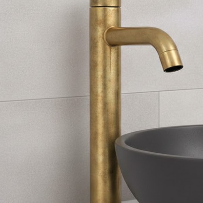 Close-up of Castello unlacquered solid brass vessel sink faucet showing natural living brass finish and curved spout detail.