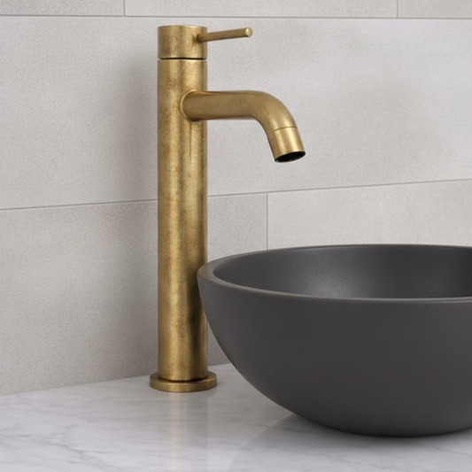 Castello unlacquered solid brass single-lever vessel sink faucet installed in modern bathroom vanity.