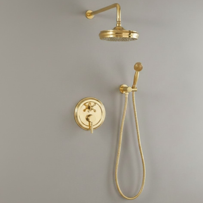 Close-up of the solid unlacquered brass circular control valve and lever handle against a neutral wall.