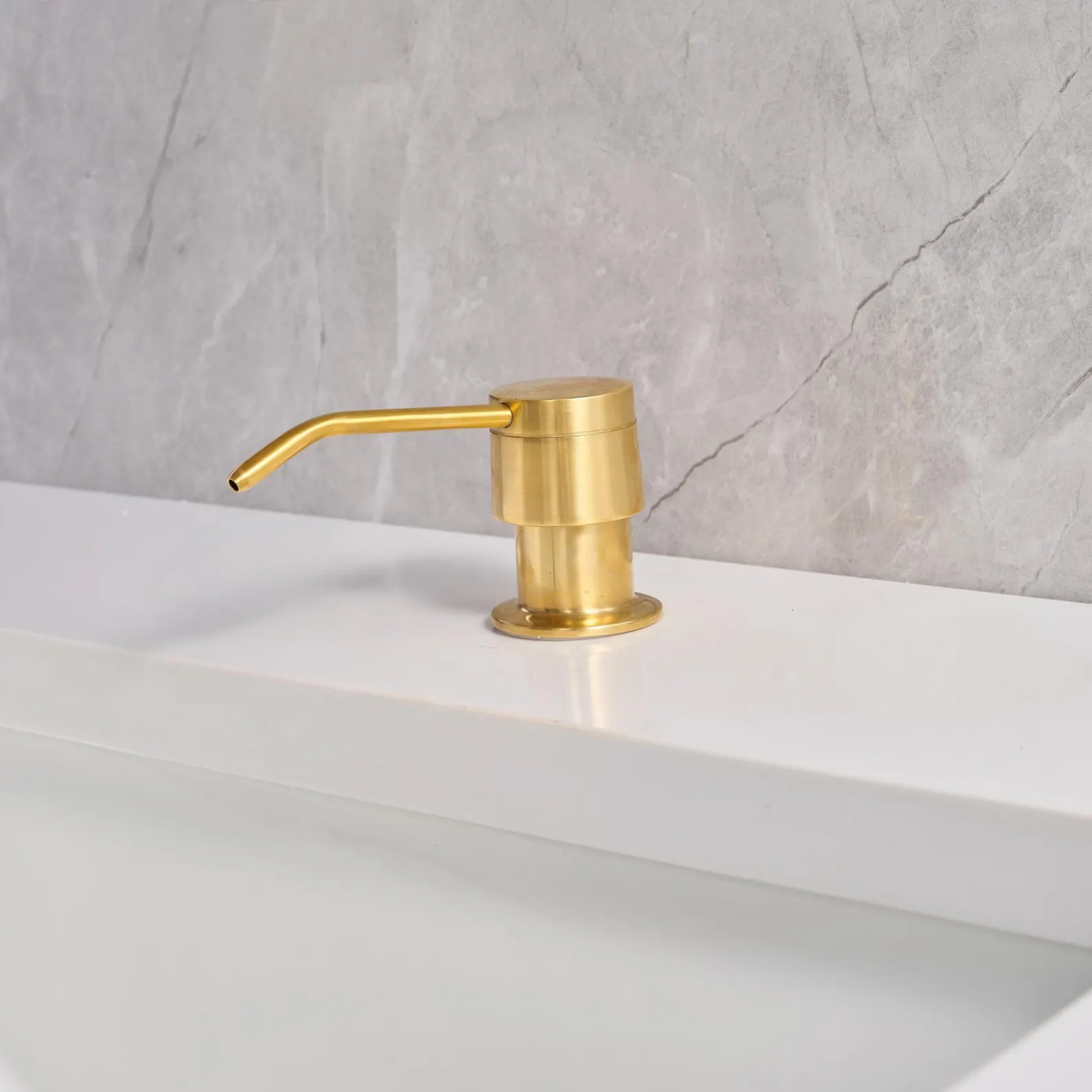 Side view of a solid unlacquered brass soap pump showing the elegant 4-inch spout reach and self-priming mechanism.