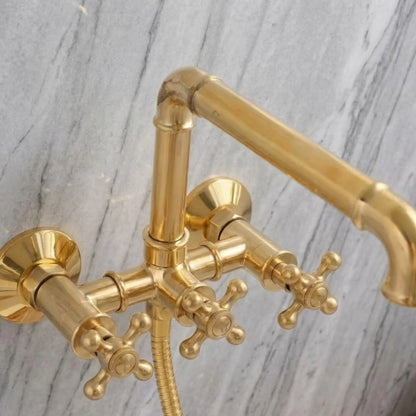 close-up unlacquered brass wall-mounted clawfoot tub faucet with cross handles and swivel spout solid brass living finish