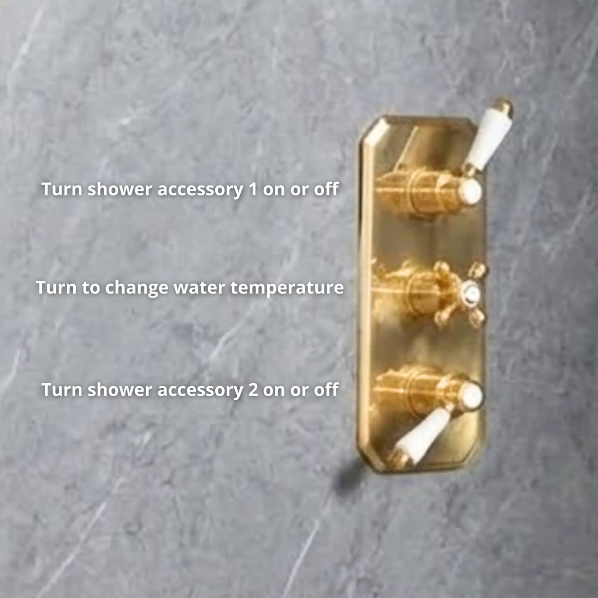 Close-up of unlacquered brass concealed thermostatic valve trim plate with three porcelain lever controls — accessory 1, temperature, and accessory 2