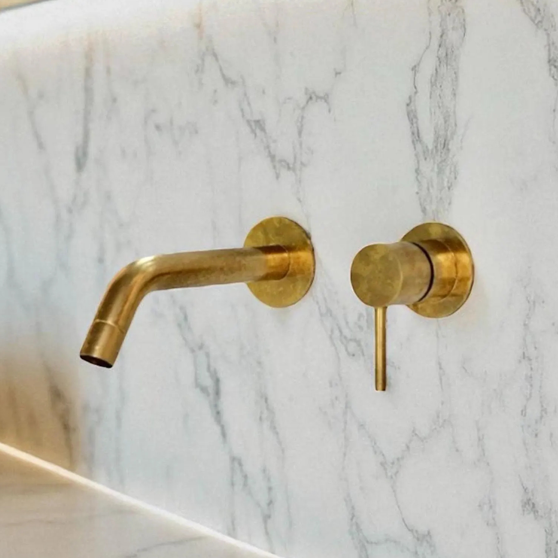 Unlacquered brass bathroom faucet with 8-inch extended spout and rotating design