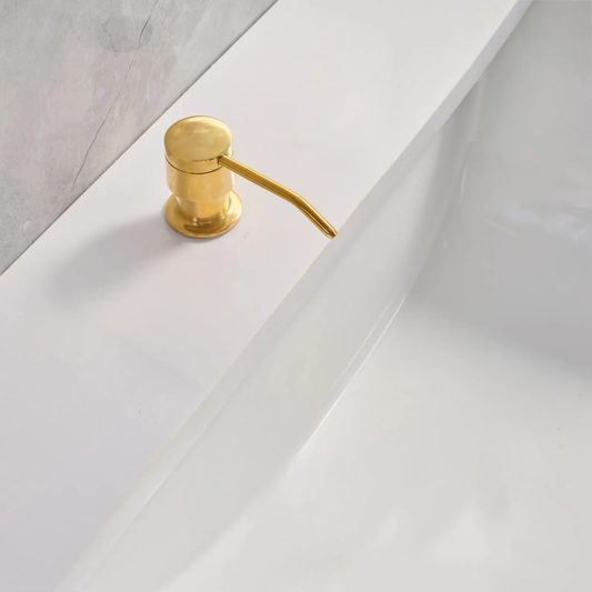 Countertop-mounted unlacquered brass soap and lotion dispenser with a 360-degree rotating spout against a green tile backsplash.