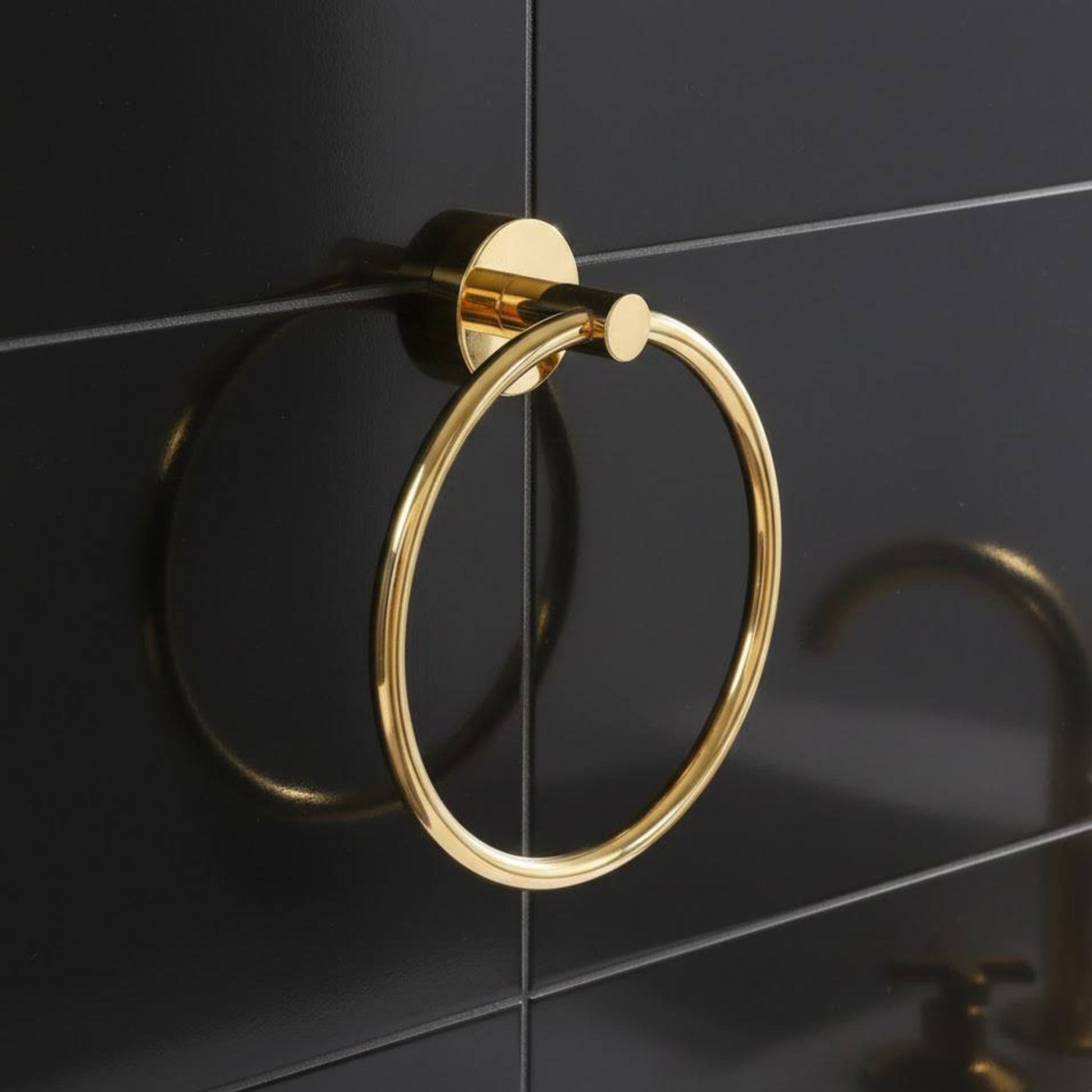 Unlacquered brass towel ring wall-mounted in bathroom with vintage solid brass finish