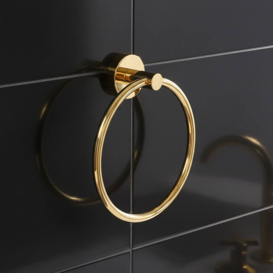 Unlacquered brass towel ring wall-mounted in bathroom with vintage solid brass finish
