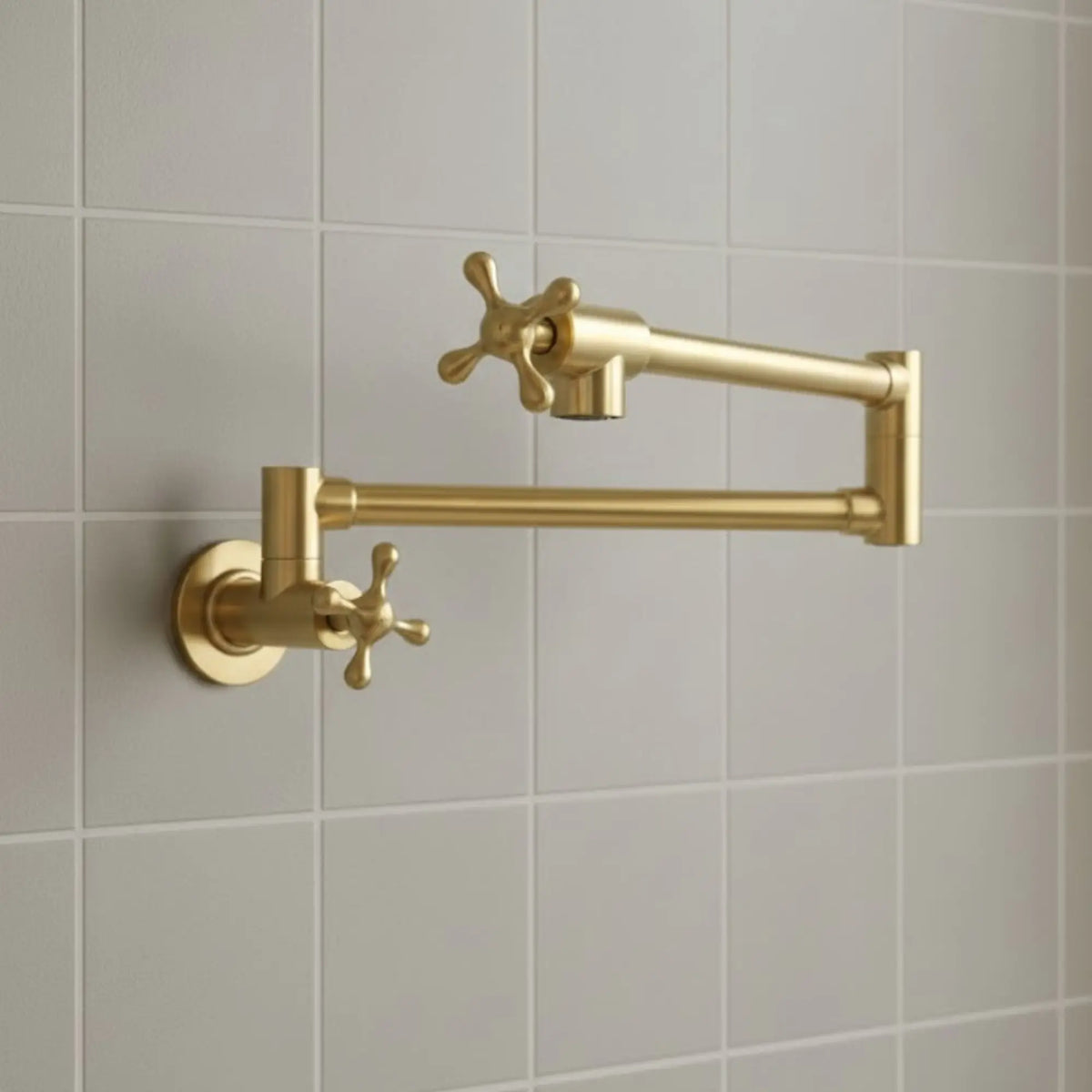 Gold kitchen faucet mounted on a tiled wall